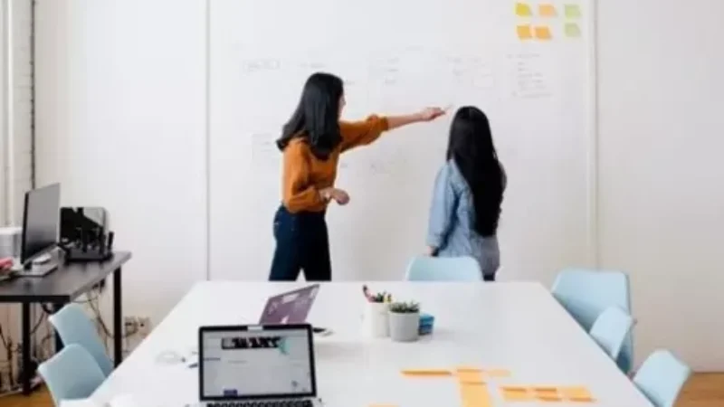 Two-women-in the-office near-white-bored